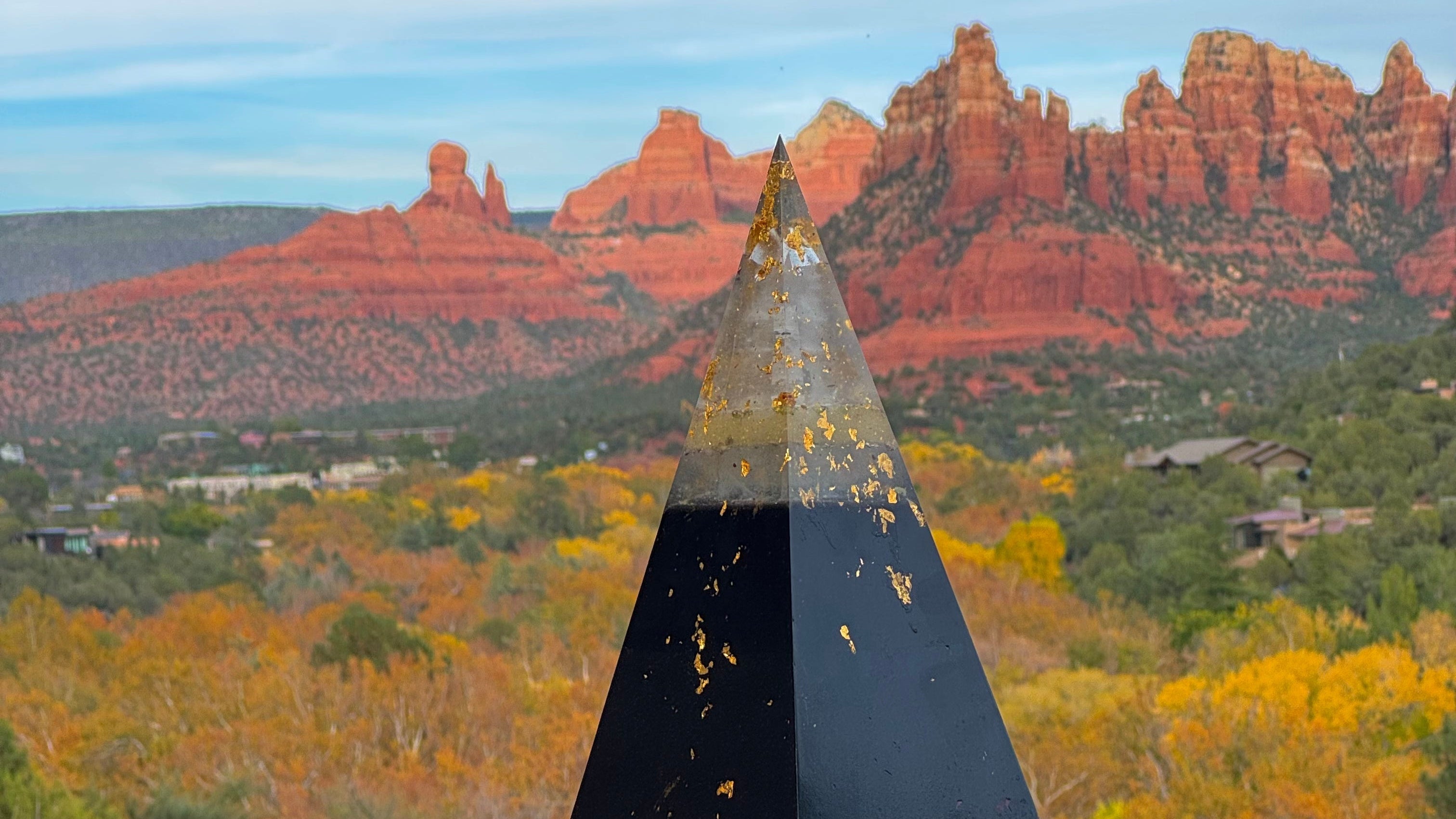Black Sun orgone pyramid apex against Sedona autumn foliage handcrafted by Orgonomy